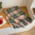 Green and pink plaid scarf with fringe and a sewn label on a wooden background - Pink & Green