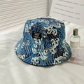 Detail view of a navy blue bucket hat with wave pattern and embroidered logo patch - L (58-60cm) / NEW Label - Blue