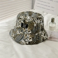 Detailed close-up of reversible bucket hat featuring wave patterns and woven side label - L (58-60cm) / NEW Label - Green
