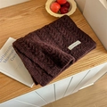 Solid burgundy knit scarf featuring thick texture and a white woven brand label - Purplish Red