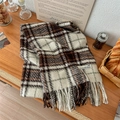 Classic plaid tassel scarf in earth tones laid on a wooden desk with a cozy winter vibe - Beige Coffee Plaid