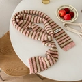 Pink, brown and white striped knitted scarf with label on cozy round table - Pink Stripe