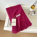 Solid magenta wool scarf with long tassels and soft texture shown on a white table - 175cm+ / Rose Purple