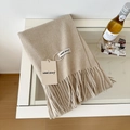 Solid beige wool scarf with tassels and product tags on white table for autumn winter - 175cm+ / Deep Beige
