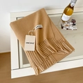 Soft wool scarf in warm camel color featuring elegant fringe edges and a minimalist tag - 175cm+ / Camel