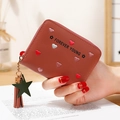 Brown PU leather wallet featuring colorful heart embroidery and star tassel detail - Dust Rose