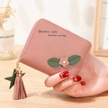 Pink short zip-around wallet with floral accents and star tassel in lychee leather - Lotus Pink
