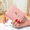 Pink dolphin print women's short wallet with tassel charm and clover zipper detail - Pink