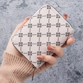 Litchi pattern card wallet in beige with black floral print shown in hand - Pink