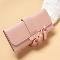 Close-up of pink long leather wallet with lychee texture and buckle closure - Pink
