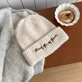 Beige ribbed knit beanie featuring colorful dachshund embroidery in a cozy winter setting - Hat / Beige