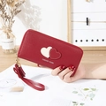 Red long faux leather zipper wallet featuring heart patch and tassel wrist strap - Red