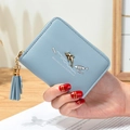 Light blue faux leather wallet with golden dolphin charm and long tassel accent - Light Blue