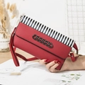 Red pebbled leather crossbody bag with black and white stripes and black chain - Red