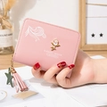 Pink short zip wallet for women featuring a rose metal badge and pink tassel charm - Pink