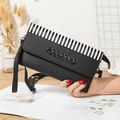 Black litchi grain crossbody phone bag with chain accent and striped edge detail - Black