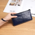 Deep blue long zippered wallet for women with wrist strap in polished leather finish - Dark Blue