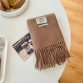 Classic camel 100% wool scarf with soft fringe details on a warm lifestyle background - Mocha