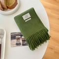 Grass green 100% wool scarf with fringe and minimalist tags in a cozy home setting - Grass Green