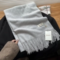 Soft light grey baby velvet scarf with fringe detail and brand tag on a suit jacket - Light Brown