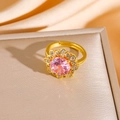 Macro shot of gold flower ring with pink gemstone center and adjustable open band - Gold Ring