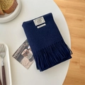 Dark blue 100% wool scarf with fringe and white woven label on a white table - Navy Blue