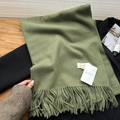 Soft grass green scarf with tassels displayed on a black blazer with cashmere feel - Army Green