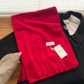 Solid red winter scarf with soft fringes and baby cashmere feel shown on a black suit - Wine Red