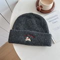 Dark grey knitted beanie featuring a running dog embroidery and Lucky Pip Egg text - Hat—Dark Gray