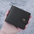 Minimalist black pebble-grain faux leather bi-fold wallet with a gold metal snap closure - Black