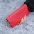 Red pebbled leather long wallet with snap button and golden chain ring detail - Red