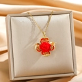 Detail of red rose pendant with gold hollowed petals on a champagne silk jewelry box - Hollow Four Leaf Petal Rose Necklace (10666)