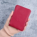 Red lychee grain leather mini wallet with gold zipper detail held in hand - Red
