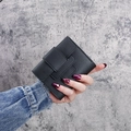 Short black trifold leather wallet for women with pebble texture and snap closure - Black
