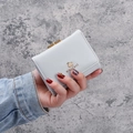 Light grey tri-fold small purse with golden elephant logo and metal clasp closure - Gray