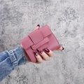 Pinkish purple PU leather short tri-fold wallet for women held by model - Deep Pink