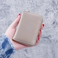 Taupe litchi pattern leather card holder with gold zipper and minimalist design - Gray