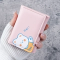 Pink trifold wallet with cute cartoon bear illustration and neat white stitching detail - Pink