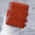 Vintage brown leather short wallet for women featuring a zip closure and retro buckle detail - Brown