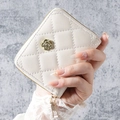 Elegant white quilted wristlet wallet with golden camellia flower clasp and zip closure - Off-white