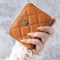 Elegant brown quilted wristlet wallet with golden camellia motif and smooth zipper finish - Brown