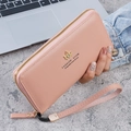 Pale pink long zip-around wallet with lychee leather texture and golden crown logo - Pink