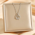 Elegant silver-toned heart and Eiffel Tower pendant necklace on a gold jewelry box display - Silver Heart Eiffel Tower (8707)