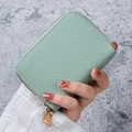 Mint green pebble leather card holder wallet with gold zipper closure held by hand - Mint Green