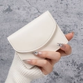 Minimalist ivory PU leather card holder wallet with quilted edge held in hand - White