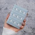 Light blue embroidered daisy short wallet featuring quilted faux leather and pink zipper - Blue