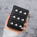 Short black PU leather wallet for women with elegant white daisy embroidery and zipper - Black