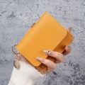 Slim bright yellow lychee leather card holder with gold keychain and secure flap closure - Yellow