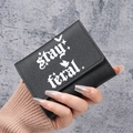 Slim tri-fold black faux leather wallet with Stay Feral bat design and star patterns - Black