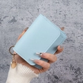 Light blue pebble grain leather card holder with gold key ring and metal charm - Blue